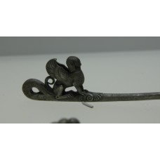 Silver items with granulation, winged man on the tip